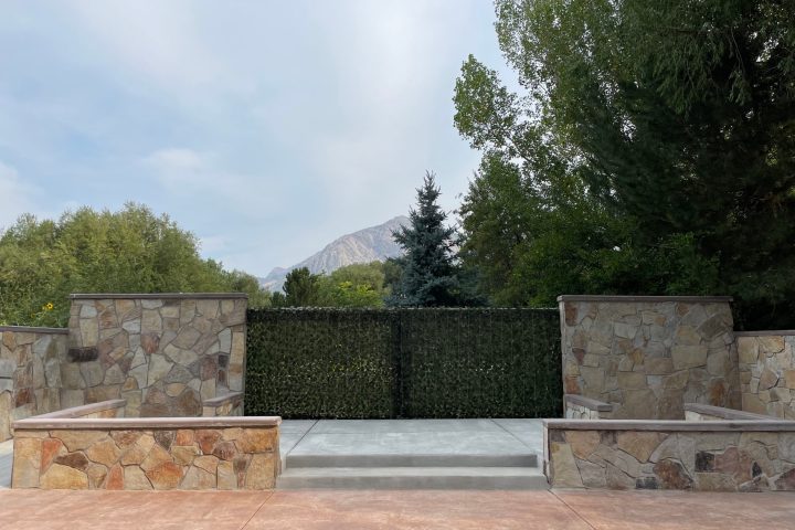a person sitting on top of a cement bench