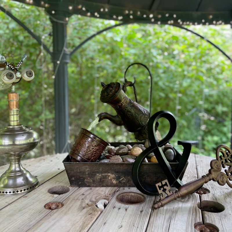 a glass of wine sitting on top of a wooden table