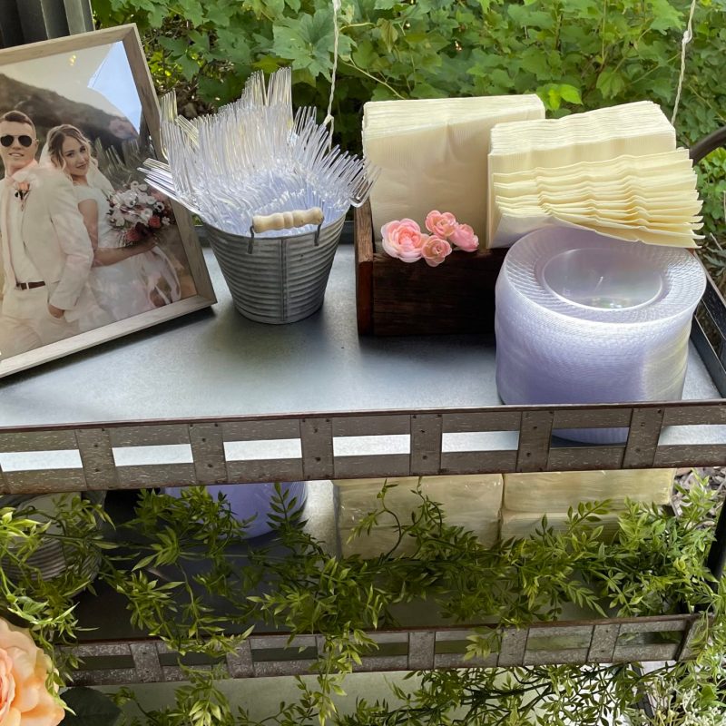 a vase of flowers sits on a picnic table