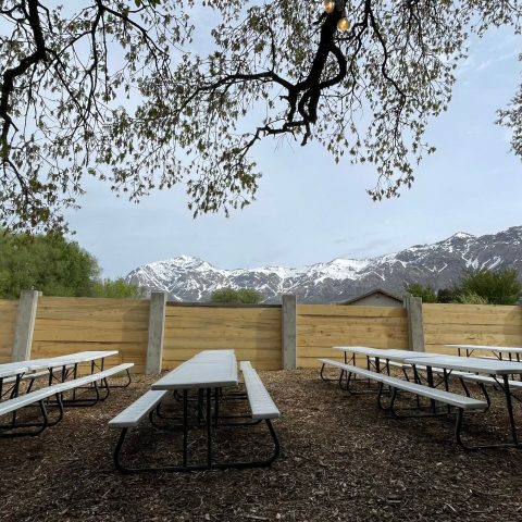 a wooden park bench next to a body of water