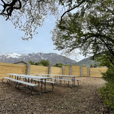 a wooden park bench next to a body of water